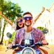 Man driving a moped with women on back